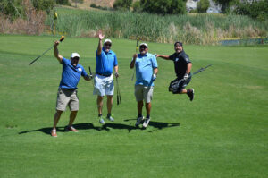 Golfers jumping on the golf fairway