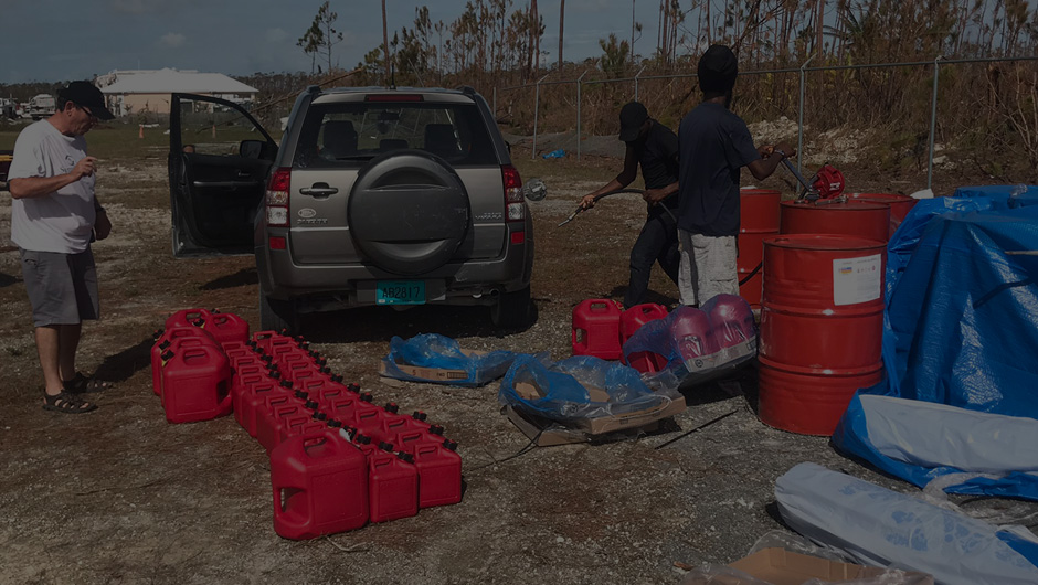 Volunteers gathering fuel jugs after Hurricane Dorian