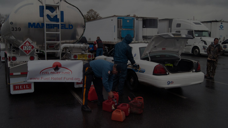 Photo of volunteers unloading fuel from a truck