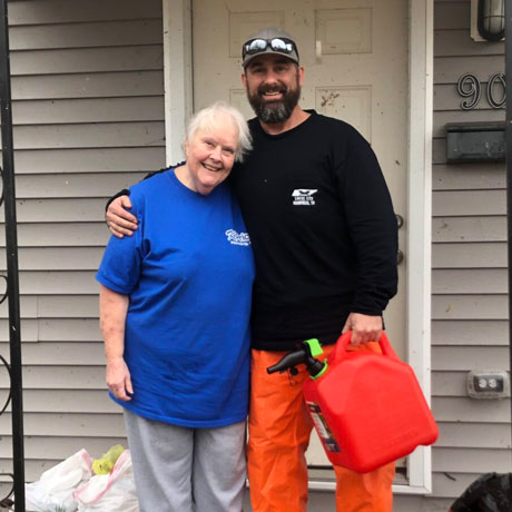 Fuel relief volunteer helping a citizen