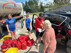 Volunteers fueling up cars